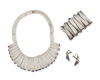 2179
A Group Of Mexican Silver And Amethyst Jewelry
Circa late 20th century
Two stamped: RTA / Hecho en Mexico / Mexico / DF / Silver; further variously stamped: 925 / 970 / [design number]; earrings stamped: RA / Sterling / 925 / Mexico
Comprising a sterling silver necklace with narrow matchstick links tipped with cut amethyst (No.35C; 17" L x 1.625" H), together with a similar matchstick design hinged link bracelet with amethyst tips (No. 48 PY; 7" L x 1.625" H), and pair of silver and amethyst earrings (Each: 1.375" H), 4 pieces
371.7 grams gross
Estimate: $800 - $1,200