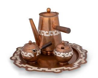 2211
A Platería Victoria Copper Coffee Service
Ana María Nuñez De Brilanti (1910-1999)
Mid-20th century; Taxco, Mexico
Stamped: Victoria / Mexico / Taxco / Copper / 482
Comprising a round tray (13.25" Dia.), a coffee pot (8" H x 7.5" W x 6.25" D), a sugar (4" H x 3.25" Dia.), and a creamer (4" H x 5.5" W x 3.75" D), each with an applied silver band and a shaped tray, 4 pieces
Estimate: $400 - $600