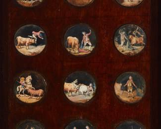 1237
Late 19th century
A Set Of Framed Bullfighting Toreador Painted Miniatures
Two illegibly signed
A framed set of twelve painted paper miniature roundels, each depicting various bullfighting scenes and figures, and each covered with glass and secured with brass-colored metal edges, all mounted to a wood plaque held in a copper and tin frame
Each roundel: 1.5" Dia
Estimate: $600 - $800