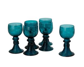 1052
Late 19th/early 20th century
A Set Of Continental Roemer Rummer Wine Goblets
Each unmarked
The glass cups, each featuring a dual cipher of Emperor Maximilian I and Empress Carlotta of Mexico etched to the sides with grape vine motif above a flared ribbed trunk with applied spotted prunts, 6 pieces
Each: 4.875" H x 2.5" Dia.
Estimate: $1,000 - $2,000