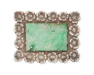 1231
A Fred Davis Silver Brooch With Carved Greenstone
Frederick W Davis (1880-1961)
Pre-1948; Mexico City, Mexico
Stamped: FD / Silver / Mexico
A rectangular silver brooch with floral motif frame-style border and central carved jadeite
2" H x 2.5" W
32.1 grams gross
Estimate: $200 - $400