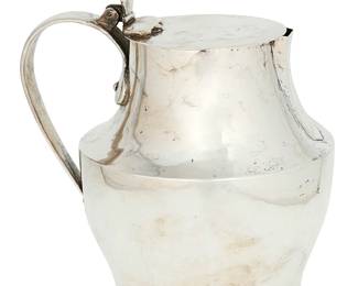1093
Mid-20th century
A Mexican Sterling Silver Pitcher
Marked to underside: Sterling / Mexico / .925
The pitcher with flat hinged lid and riveted handle
7.25" H x 7.5" W x 5.75" D
27.45 oz. troy approximately
Estimate: $300 - $500