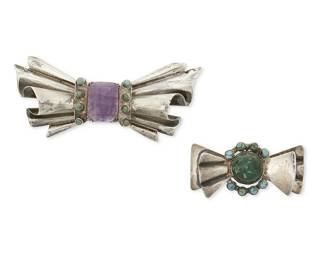 1327
Two Mexican Silver Brooches With Set Stones
Mid-20th century
Each appears unmarked
Two Fred Davis-style bow brooches with set amethyst and turquoise
Larger:1.25" H x 3.25" W; smaller: 0.75" H x 2" W
38.7 grams gross
Estimate: $300 - $500