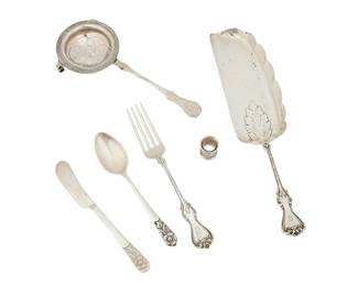 1320
Circa 1930s/40s
A Group Of Mexican Silver Flatware Items
Knives, spoons and scarf cinchers marked for Sanborns and for sterling; forks and serving utensil marked: Sterling / Diener Hermanos Mexico
Comprising 5 butter spreaders (6"), 4 teaspoons (5.625"), 4 dinner forks (6.875"), 5 scarf cinchers (0.875" H x 0.75" Dia.), 1 serving utensil (10.75"), and 1 tea strainer (7.5"), 6 personalized, 20 pieces
22.9 gross oz. troy approximately
Estimate: $300 - $500