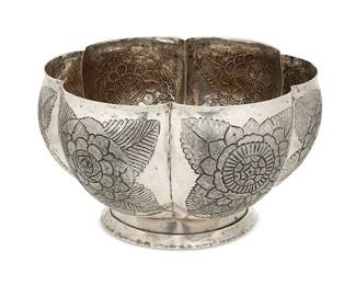 1102
Circa 1930s; Mexico City, Mexico
A Sanborns Sterling Silver Bowl
Marked to underside: [Three owls] / Sanborns Mexico / Sterling
The footed bowl with six lobes, each chased and incised floral medallions
5.625" H x 9.75" Dia.
33.4 oz. troy approximately
Estimate: $500 - $700