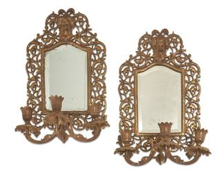 1269
19th century
A Pair Of Continental Brass Mirrored Wall Sconces
Each appears unmarked
The gilt brass three-light sconces, each with openwork scrolled foliate motifs and high-relief Bacchus mask, flora-form bobèches, and inset beveled mirror, 2 pieces
Each: 16" H x 10.75" W x 7" D
Estimate: $300 - $500