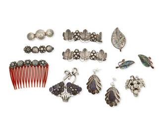 1337
A Large Group Of Mexican Silver And Stone Set Jewelry Items
Mid-20th century
Four marked for Mexico and silver; further variously marked: Sterling / Taxco / 925 / Miguel Plata Paron / CCC / [Eagle 3] / Cuermor
Comprising three silver brooches in various styles, including a flower basket brooch with set amethyst cabochons (2.375" H x 2.25" W), as well as a mother of pearl inlay leaf brooch 1.75" H) with a pair of matching screwback leaf earrings (each: 1.5" H), a pair of silver repoussé scallop motif pierced earrings with amethyst teardrop dangles (each: 1.875" H), and four silver floral and grape motif ornaments for hair combs (largest: 1" H x 3" W), 12 pieces
76.5 grams gross
Estimate: $300 - $500
