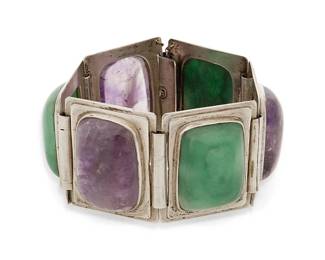 1174
A Fred Davis Mexican Silver And Set Stone Link Bracelet
Frederick W Davis (1880-1961)
Pre-1948; Mexico City, Mexico
Stamped: FD for Fred Davis: Further stamped: Sterling / Made in Mexico
A chunky bracelet designed with alternating links of set cushion cabochon amethyst and greenstone panels
6.75" L x 1.375" H
90.4 grams gross
Estimate: $800 - $1,200