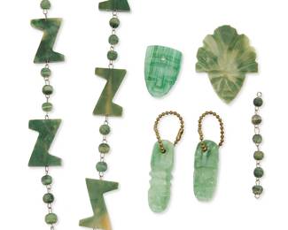 1170
A Group Of Carved Greenstone Jewelry Items
Mid-20th century
Appear unmarked
Comprising a pendant necklace with detached carved mask and large abstract greenstone beads on wire (24" L x 0.875" H), and three carved greenstone masks with holes, two with a key chain (largest: 2" H), 5 pieces
Estimate: $300 - $500