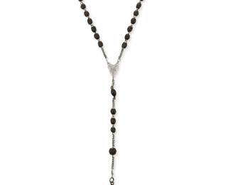 1117
A Black Bead Rosary Belonging To Fred Davis
Mid-20th century
Central lozenge marked: M
Comprising a small carved and plain wooden black bead rosary with silver-toned metal chains and a sterling silver metal cross
22" L x 5.75" H
Estimate: $300 - $500