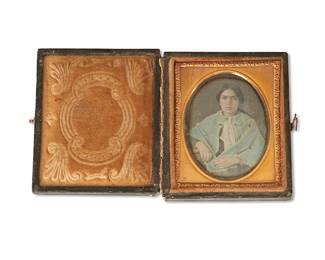 1271
19th century
A Framed Daguerreotype Portrait
The ninth plate portrait depicting a young woman in a blue-tinted shawl with earrings, framed in embossed gilt metal preserver and set into a wood case bound with applied tooled leather
Case: 2.875" H x 2.5" W x 0.625" D
Estimate: $700 - $900