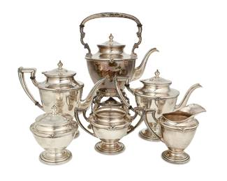 1203
Mid-20th century; Mexico City, Mexico
A Sanborns Sterling Silver Coffee And Tea Service
Each marked: [three owls] / Sanborns Mexico / Sterling
Comprising a hot water pot with a paw-footed chafing stand with handled chafer (overall: 14.5" H x 10.5" W x 7" D), a coffee pot with hinged lid (9.25" H x 10.75" W x 5.25" D), a teapot with hinged lid (8.25" H x 10.25" W x 5.25" D), a creamer (5.325" H x 6" W x 4" D), a covered sugar (5.5" H x 4.75" Dia.), and a waste bowl (4.75" H x 7.75" W x 4.75" D), 6 pieces
220.23 gross oz. troy approximately
Estimate: $3,000 - $5,000