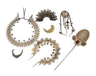 1113
18th/19th century
A Group Of Mexican Silver And Mixed Metal Santos Devotional Items
Each appears unmarked
Seven works comprising two silver stick pin ornaments, each with set stones (larger: 10.5" H x 3.125" W; smaller: 6.5" H x 2" Dia.) as well as five decorative crown headpieces in gold-toned and silver-toned metal, in various styles and sizes (Largest: 9.25" H x 7" Dia.; Smallest: 1.75" H x 2.25" W), 7 pieces
Stick pins: 96.8 grams gross
Estimate: $600 - $800