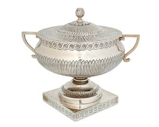 1103
Circa 1930s; Mexico City, Mexico
A Sanborns Sterling Silver Serving Bowl
Marked to underside: [Three owls] / Sanborns Mexico / Sterling
The urn-form bowl with opposed handles and chased and repoussé lid, mounted to a square chased foot
10.25" H x 12.125" W x 9.25" D
70.2 gross oz. troy approximately
Estimate: $1,000 - $1,500