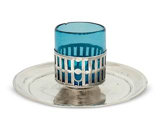 1144
19th century or earlier
A Spanish Colonial Silver Dish And Cup
Hallmarks for the Real Fábrica de Platería Martínez in Spain; with Madrid assay mark: [crown above] M; further marked: FCDA
The silver tray with a reticulated detachable holder and blue glass insert
Overall: 3.5" H x 7.5" Dia.
8.7 oz. troy approximately
Estimate: $300 - $500