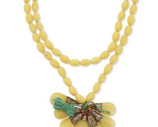 1335
A Yellow Glass Bead Necklace With Teardrop Glass Drops
Mid-20th century
Appears unmarked
Comprising a long chunky necklace strand of yellow glass beads and seven yellow glass teardrop pendant bead dangles with ornate metal beadcaps
44" L x 1.75" H
Estimate: $200 - $300