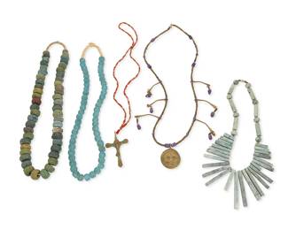 1342
A Group Of Jewelry
Mid/late 20th century
Each appears unmarked
A group of five necklaces including a pendant necklace with polished amethyst and bronze-colored beads and tabs, with a round face pendant (28" L), a necklace of orange and red glass beads with a bronze-colored cross pendant (27" L), a green hardstone bead collar necklace with graduated tabs (17" L x 2.75" H), as well as a single strand necklace of chunky stone beads in various shades of green and blue, and a single strand of blue/green glass beads (each: 25" L), 5 pieces
Estimate: $300 - $500