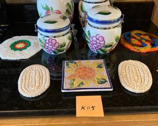 Painted ceramic canisters and decorative trivets