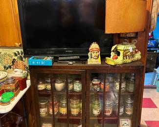 Display cabinet with numerous new candles, Oriental TV Lamp, TV’s