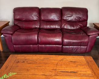 Dark red leather sofa with recliners at each end, there are a few long seam tears that were repaired with black gorilla tape, recliners work well and sofa is comfortable 7.5"W x 35"D