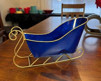 Blue and gold metal sleigh decoration, has some indentions on each side 7"H x 12"L