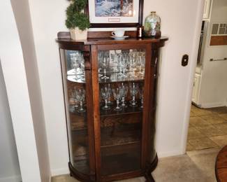 Beautiful antique Empire bow front cabinet with original curved glass
