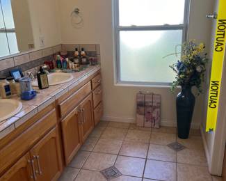 Bathroom soaps, hand lotions, wall hangings, and talk floor vase.