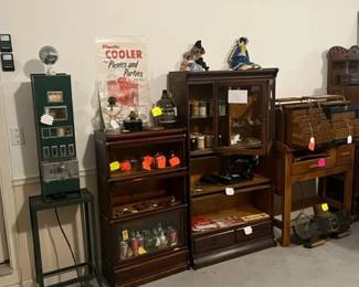 LEFT TO RIGHT, ANTIQUE CIGARETTE  DISPENSER, RARE GLOBE WERNIKE MAHOGONY 3 STACK 3/4 SIZE BARRISTER BOOKCASE, BARRISTER CABINET ON BARRISTER PIECES, AND HOBBY WORKBENCH WITH SMALL DENTAL CABINETS