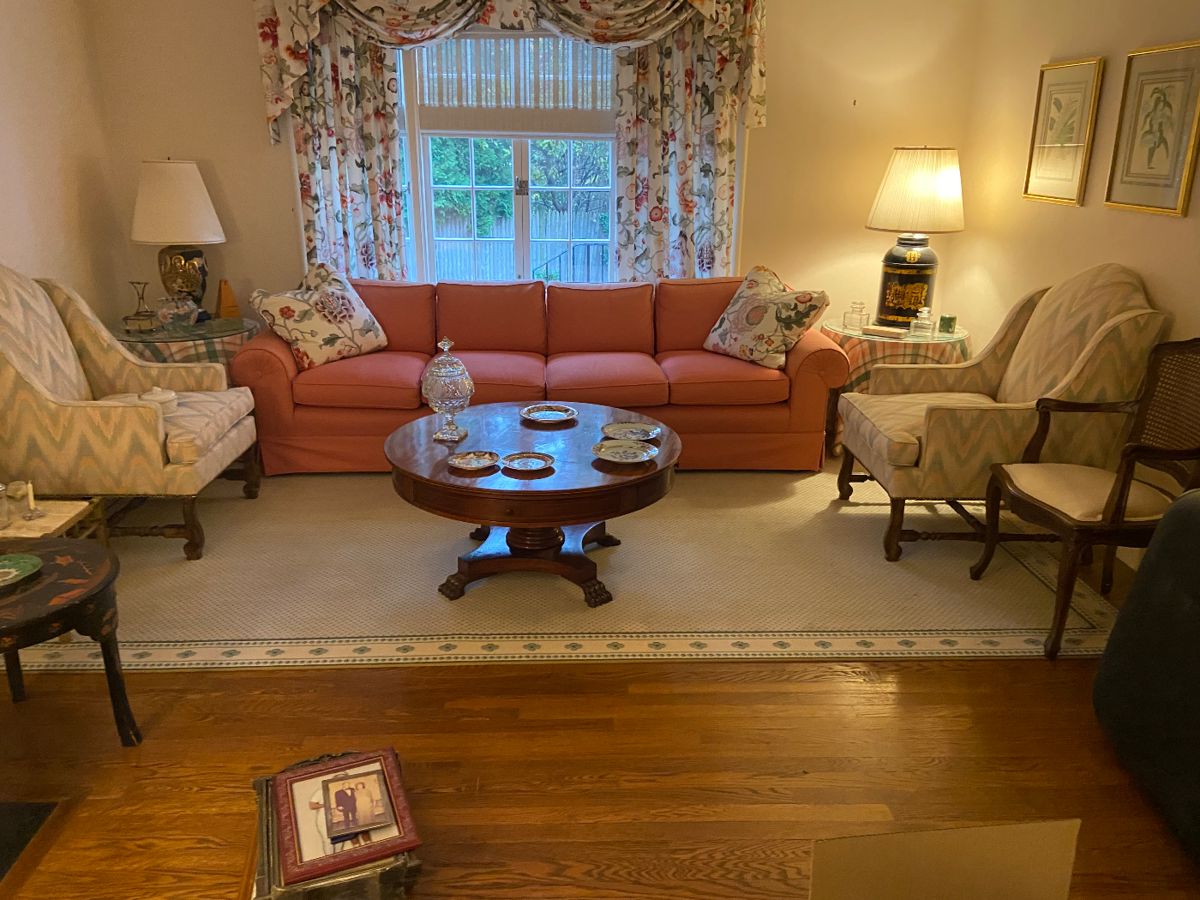 Pair of custom upholstered wing chairs, Sofa, Paw foot inlaid table.   The Rug is not for sale