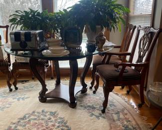 Peace lilies, glass top and wood dining table with beautiful rolling padded chairs 
