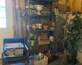 Chair, office supplies, yard chemicals, shelving with yard items, hoses, planters, etc. large silk plant