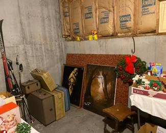 artwork and luggage, skis and ice skates small table 