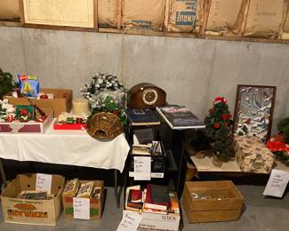 books,  Edina cabinet, Seth Thomas clock, small trees, candles and artwork