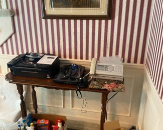 sofa table, printer, fax machine, laptop, cleaning supplies, decorative plates