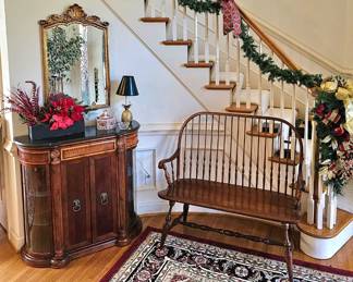Entryway with detailed cabinet with curved glass doors. Windsor settee