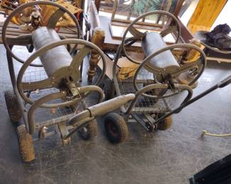 Two rolling. garden hose racks