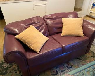 Eggplant purple plum leather couch and love seat In very nice although not perfect condition. Unique color!! 