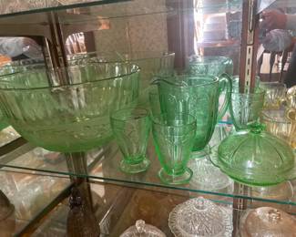 Green glass punch bowl, pitcher with glasses, and covered dish is uranium glass