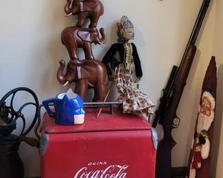 Vintage coke ice chest , wood elephants , and hunting rifle