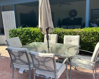 Fabulous aluminum and glass patio set with cushions and an umbrella top.