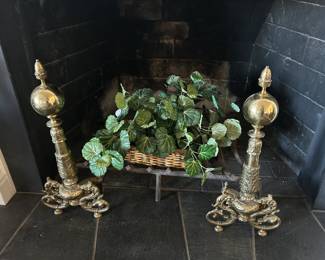 We have a pair of beautiful polished brass vintage andirons with dragon details.
