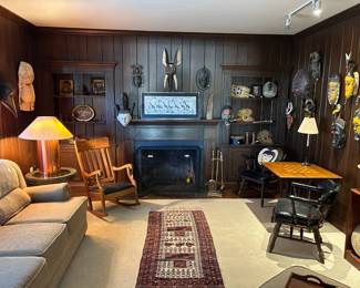 Welcome to the African room filled with tribal masks, comfy sofas, vintage rocker and checkerboard table.