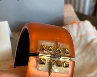 #49 Alexis Bittar orange lucite cuff (7" diam) with rhinestine - with original felt bag and Neiman and Marcus box.  $130