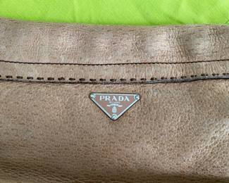 #99 - Prada small handbag leather light brown purse 	$100 - Clean condition but used. 