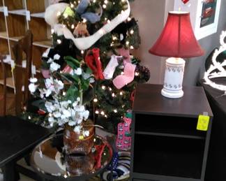Contemporary mirrored table, black cabinet and lamp with red shade. (The hat/scarf/glove tree are donations for underprivileged children. Donations welcome.)