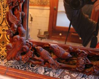 Detail on the Carved wood mirror with birds and foliage