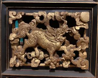 Detail on the hand carved wood Chinese gilt decorated architectural element with multiple panels 