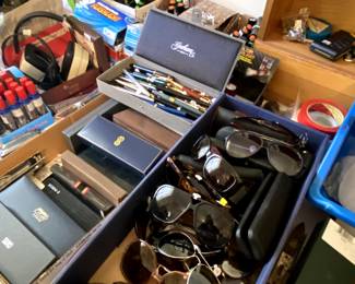 Vintage sun glasses and a huge supply of nice pens and pencils. Several sets in original cases.