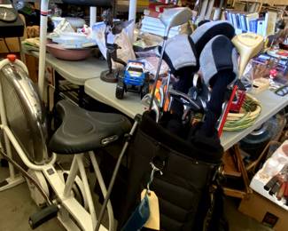 Golf clubs, Schwinn stationary bike.