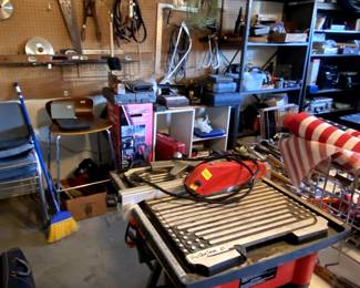 Garage is full of tools, kits, sets, shelving.
